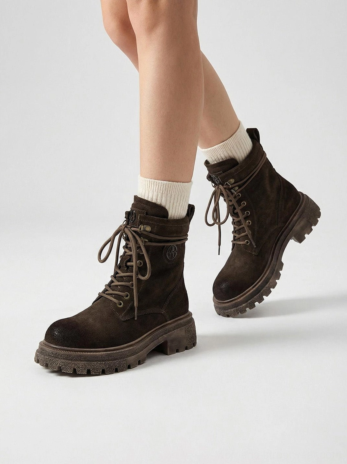 Distressed platform combat boots construction detail showing stitching quality wraparound welt durability engineering