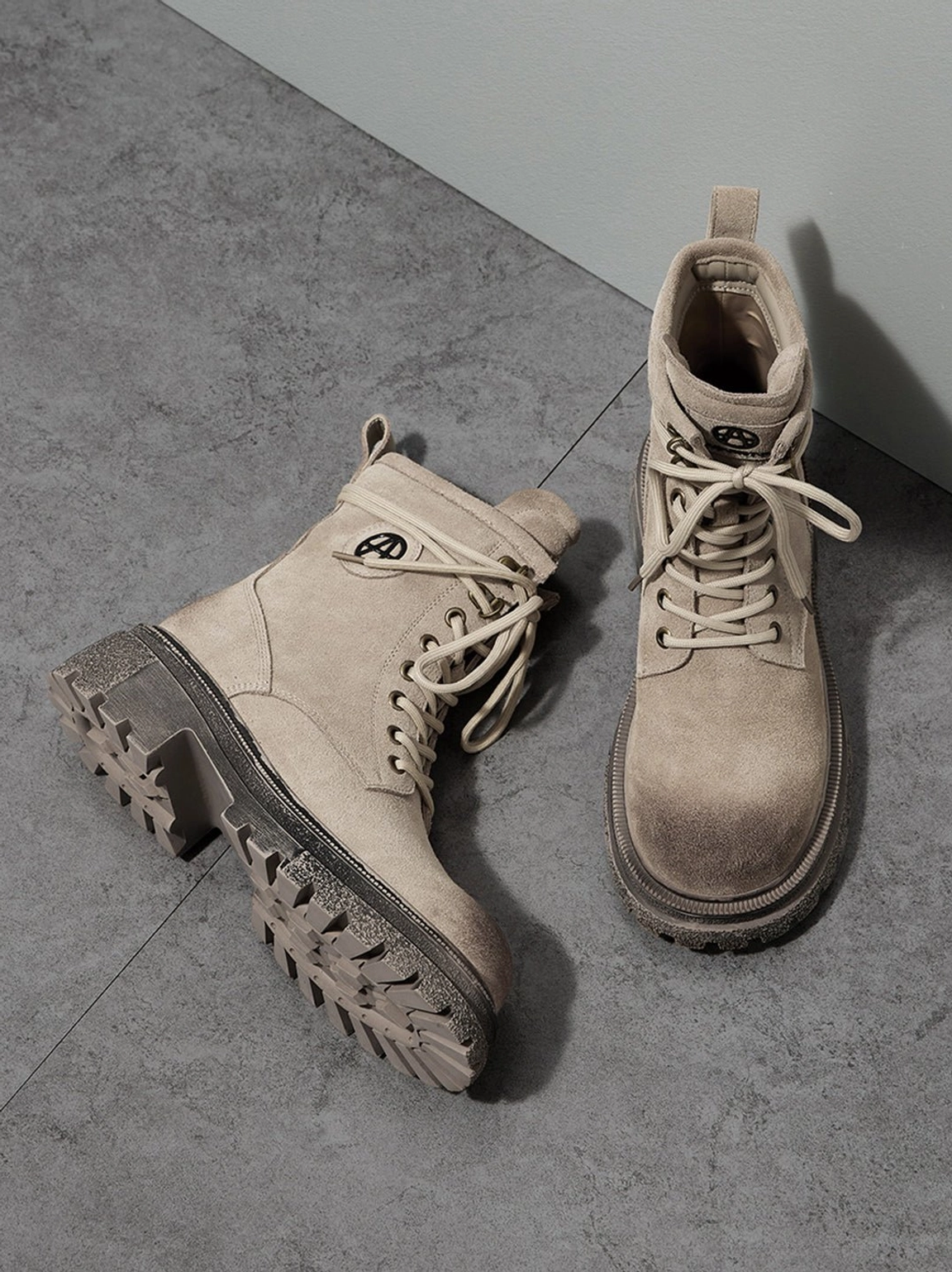 Distressed platform combat boots showing lace-up system from above revealing ankle collar opening and tongue construction