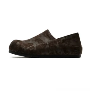 Distressed dark brown suede clogs with collapsible heel slip-on construction and black rubber outsole for casual streetwear outfits