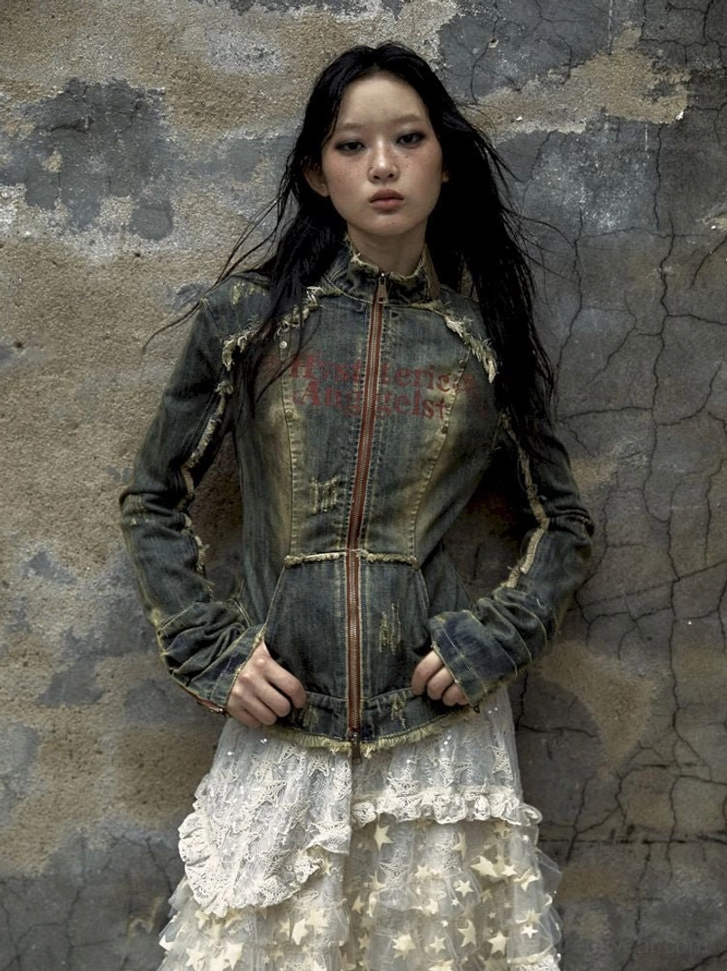 Faded blue distressed denim corset jacket with front zipper and frayed edges styled with a tiered lace midi skirt