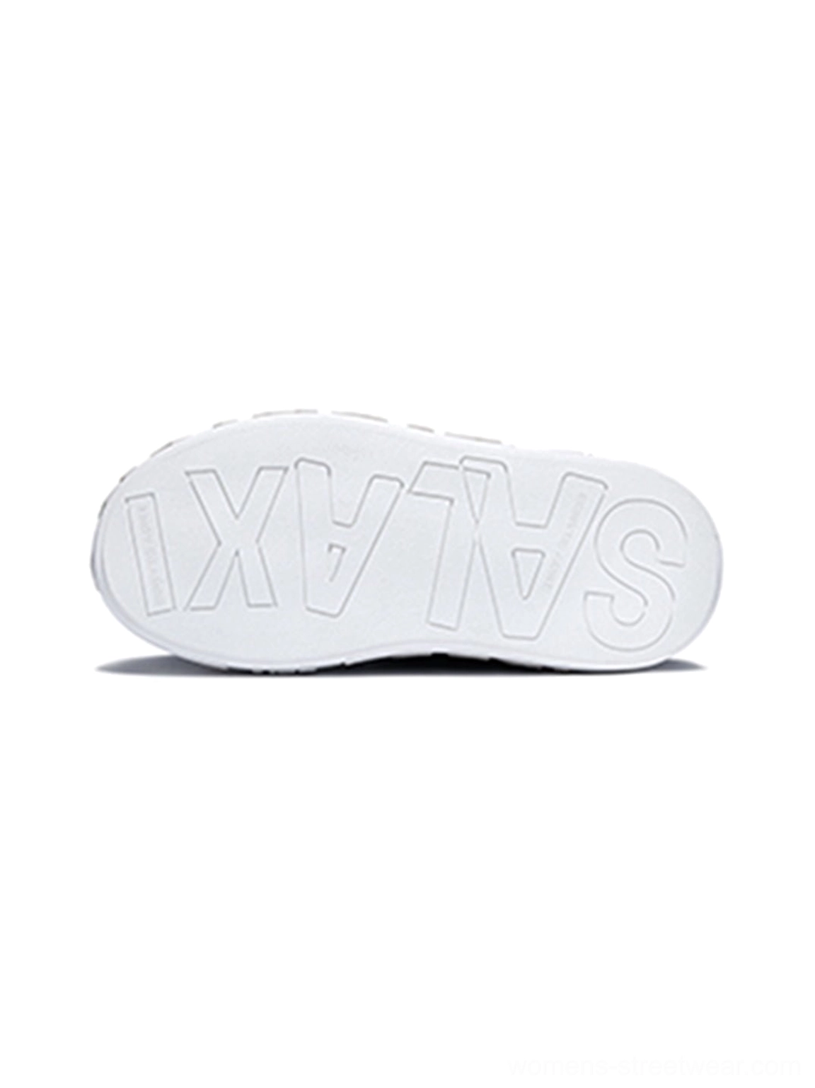 Close-up view of the thick white rubber outsole on a distressed denim platform skate sneaker