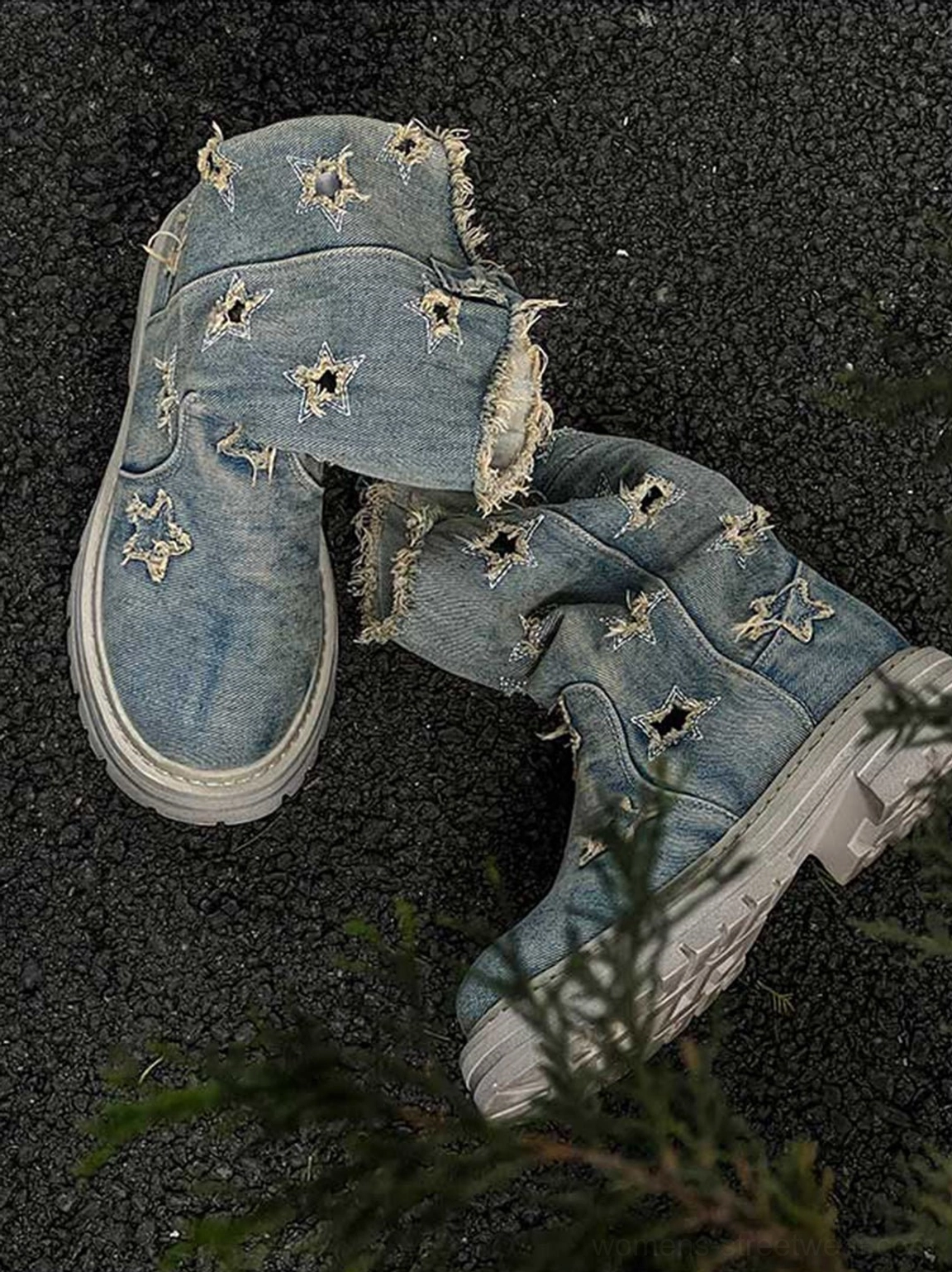 Flat lay of distressed denim star cutout platform boots showing frayed collars, embroidered stars, and textured anti-slip tread