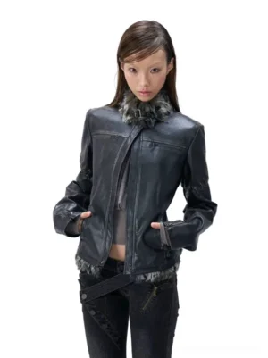 Female model wearing a distressed charcoal faux leather moto jacket with plush faux fur collar and hem, fitted cropped silhouette, lace-up sleeve details, and dark Korean streetwear styling