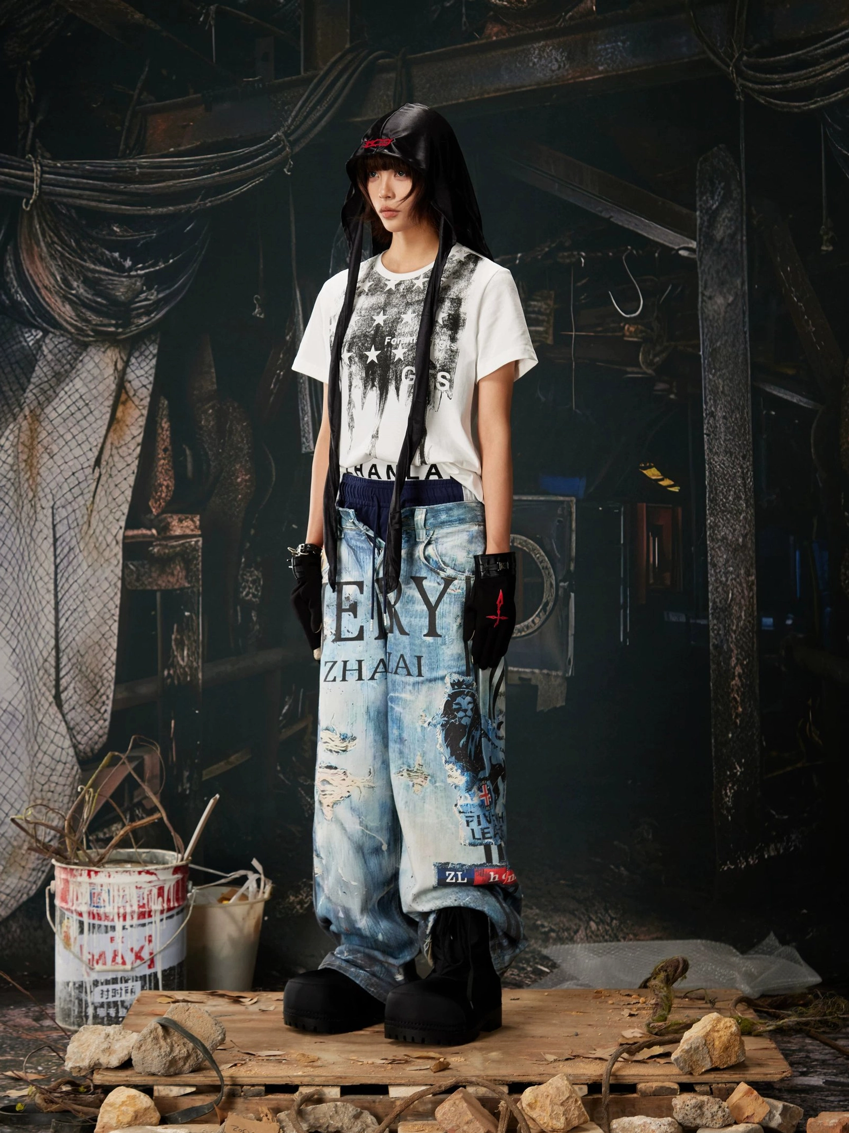 Relaxed ocean-blue wide-leg jeans with collage graphics, paint-splash details, vintage fading, and expressive urban denim styling