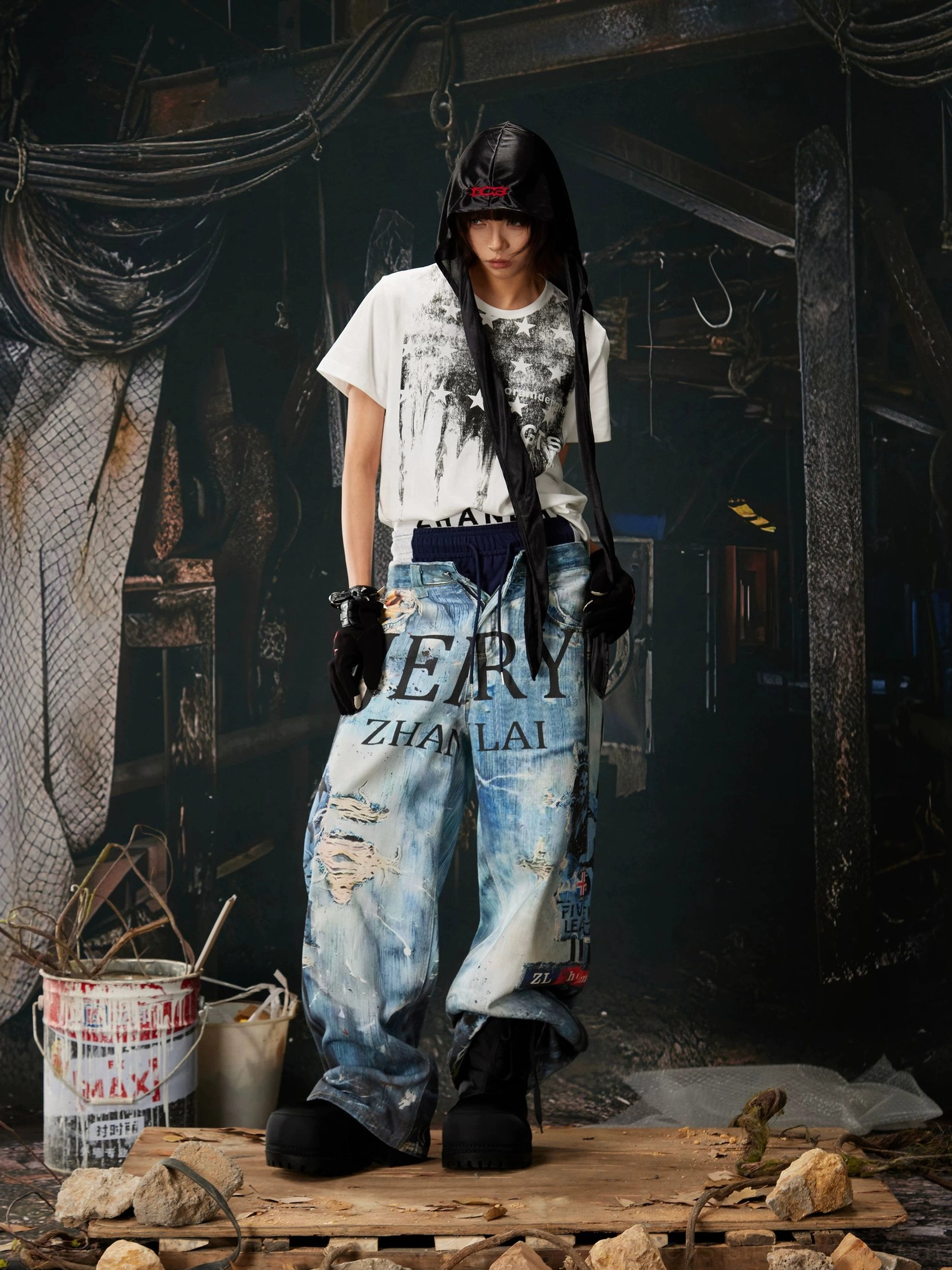 Female model wearing distressed ocean-wash wide-leg jeans with graffiti graphics, branded elastic waistband, and relaxed Korean streetwear styling