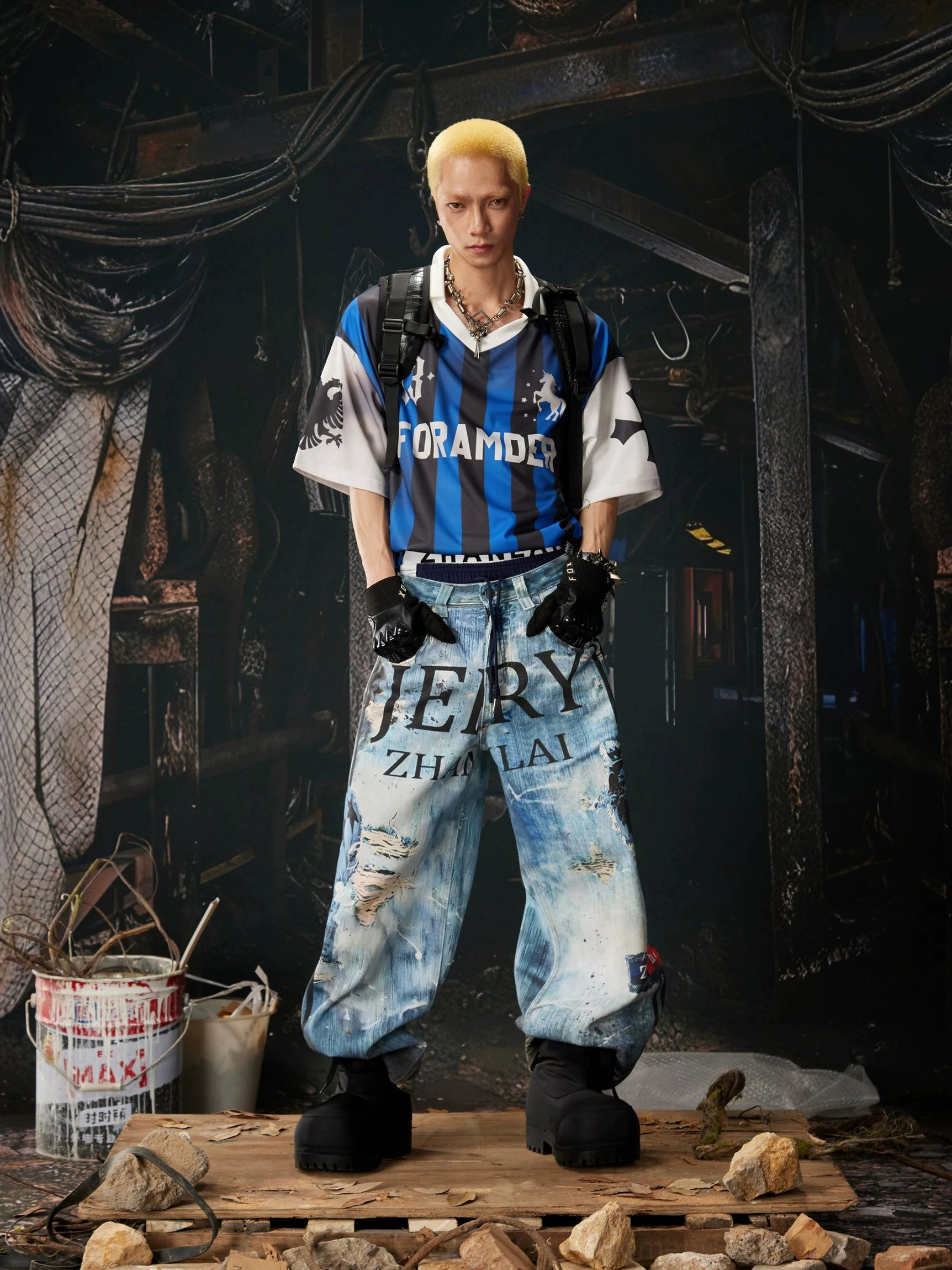 Front view of oversized distressed graffiti jeans with blue washed denim, coordinated letter prints, and loose wide-leg streetwear silhouette