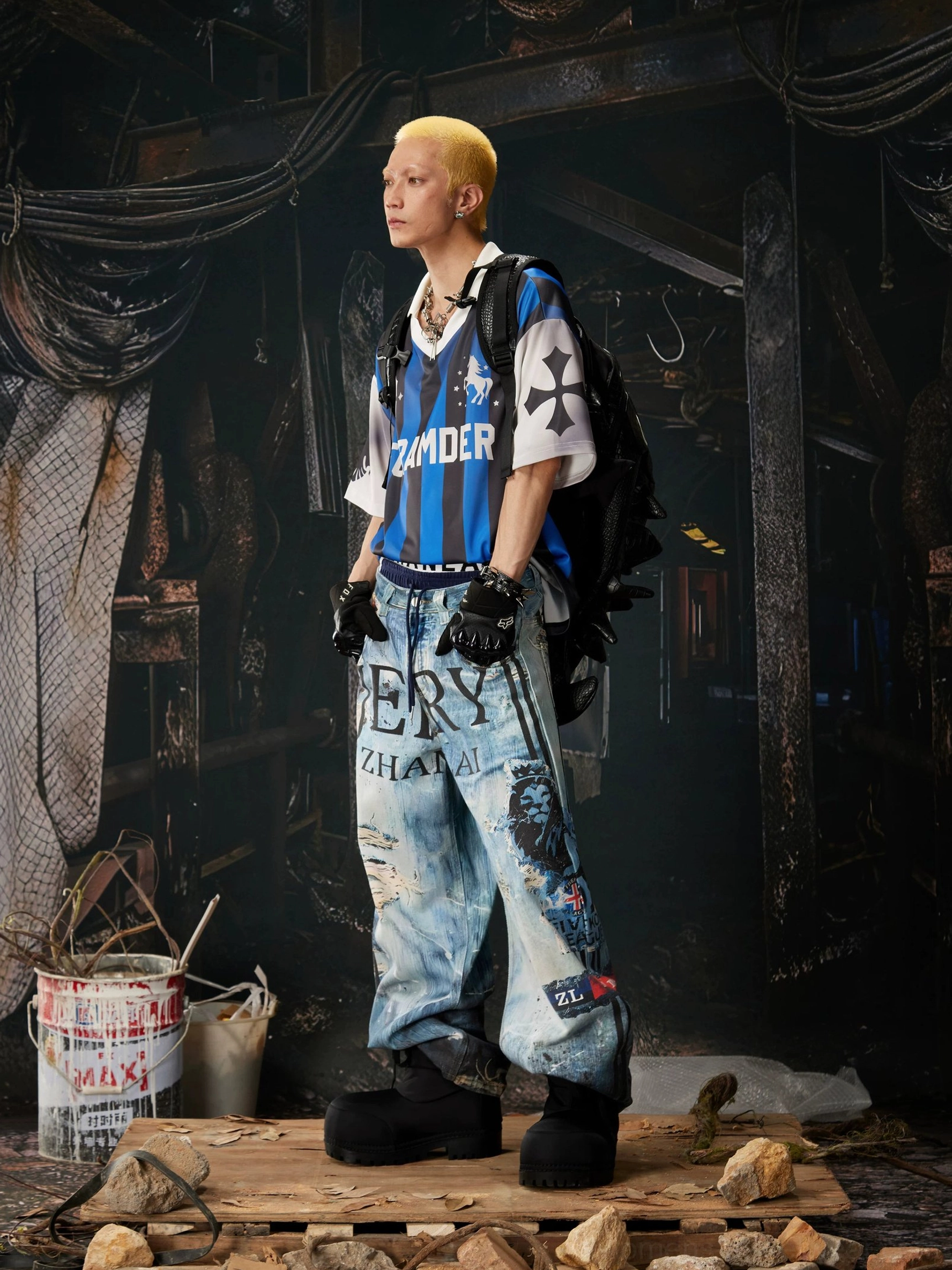 Right side view of distressed graffiti wide-leg jeans with unique graphic decals, worn blue denim finish, and coordinated streetwear details