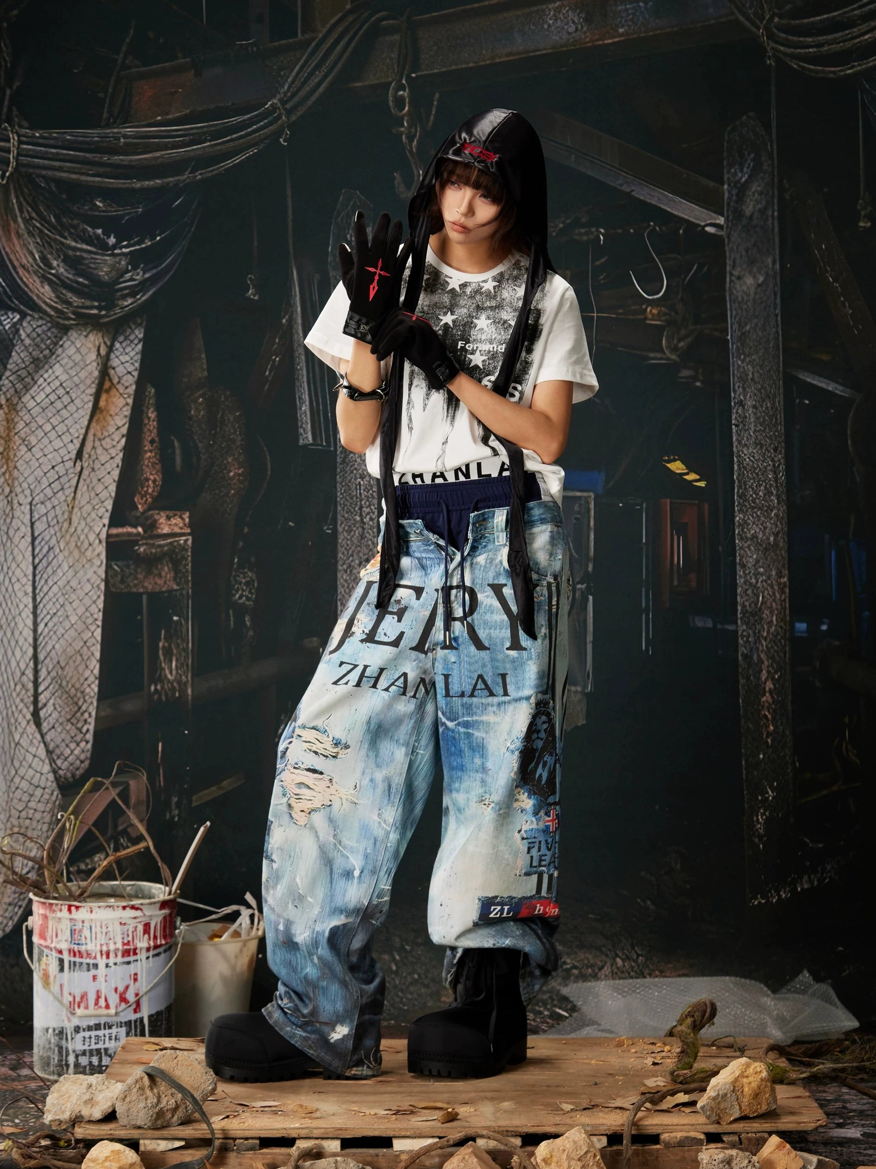 Blue graffiti wide-leg jeans with distressed denim finish, stacked hem styling, drawstring waistband, and bold Y2K streetwear design