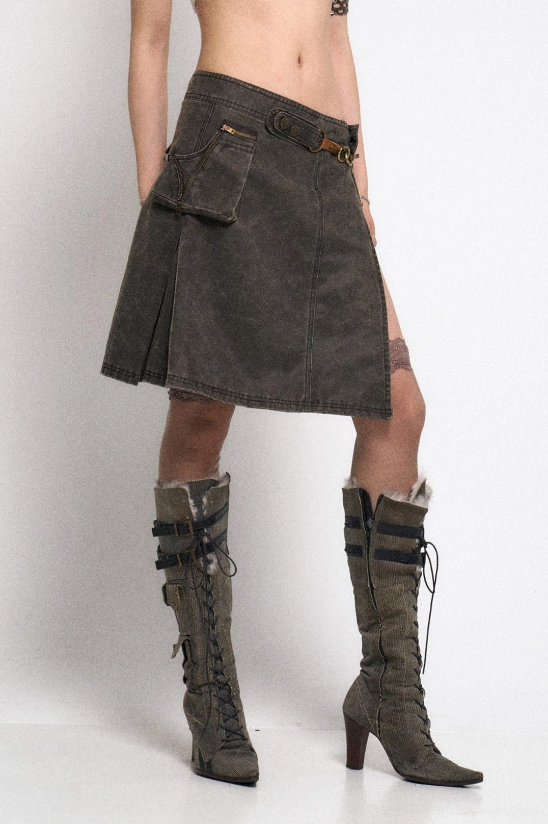 Distressed gray asymmetrical gothic cargo mini skirt with pleated hem and utility pocket back view