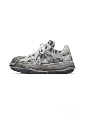 Gray distressed camo shell-toe leather skate sneaker with chunky flat laces, weathered toe cap, and thick sculpted melted rubber outsole shown from a left side three-quarter view