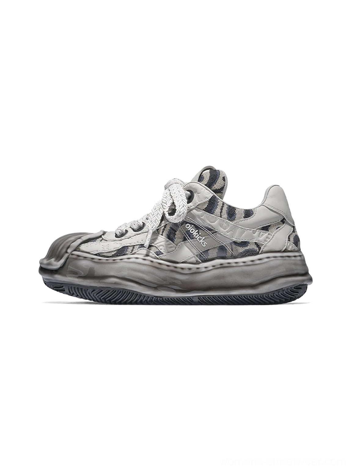 Gray distressed camo shell-toe leather skate sneaker with chunky flat laces, weathered toe cap, and thick sculpted melted rubber outsole shown from a left side three-quarter view