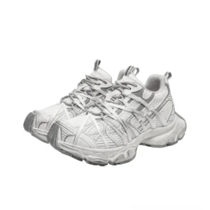 Distressed grey and off-white platform chunky sneakers shown from the front three-quarter angle with layered mesh panels, wraparound laces, and rugged elevated outsole