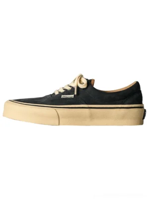 Distressed leather canvas low-top sneaker with dark faded suede upper and beige rubber sole, left side profile view on white background, showing contrast stitching details and vintage aesthetic