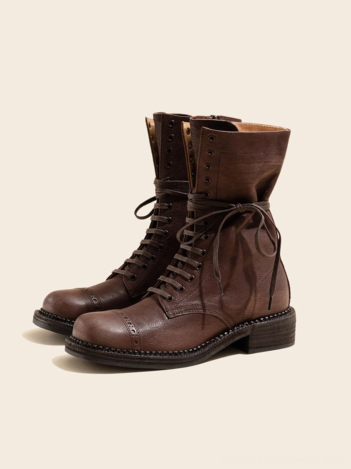 Side view of dark brown distressed leather mid-calf combat boots with rolled shaft stitched welt and low heel