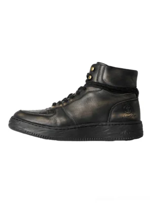 Black distressed leather combat boots with padded fold-over cuff, lace-up front, vintage brass-tone hardware, and flat rubber sole shown from the side
