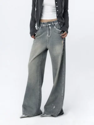 Front full-body view of distressed light blue wide-leg jeans with a faded vintage wash, relaxed mid-rise fit, and loose streetwear silhouette