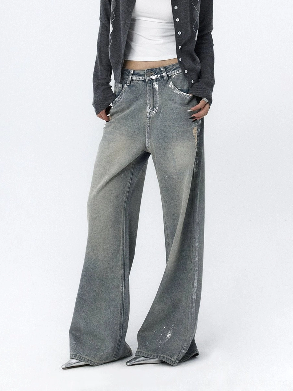 Front full-body view of distressed light blue wide-leg jeans with a faded vintage wash, relaxed mid-rise fit, and loose streetwear silhouette