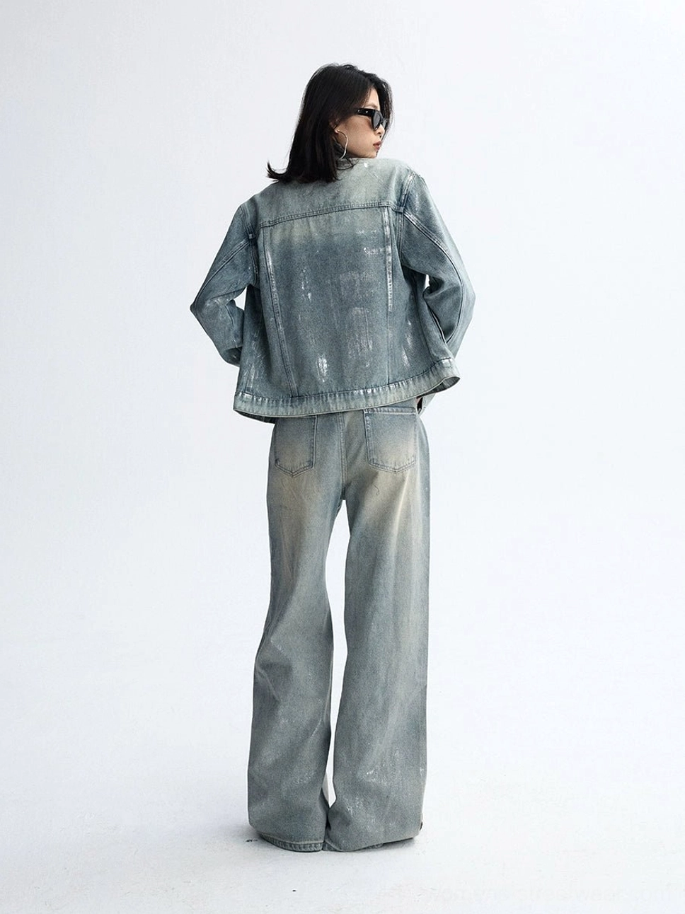 Distressed light blue wide-leg jeans styled for a modern Y2K streetwear wardrobe with a relaxed oversized denim silhouette