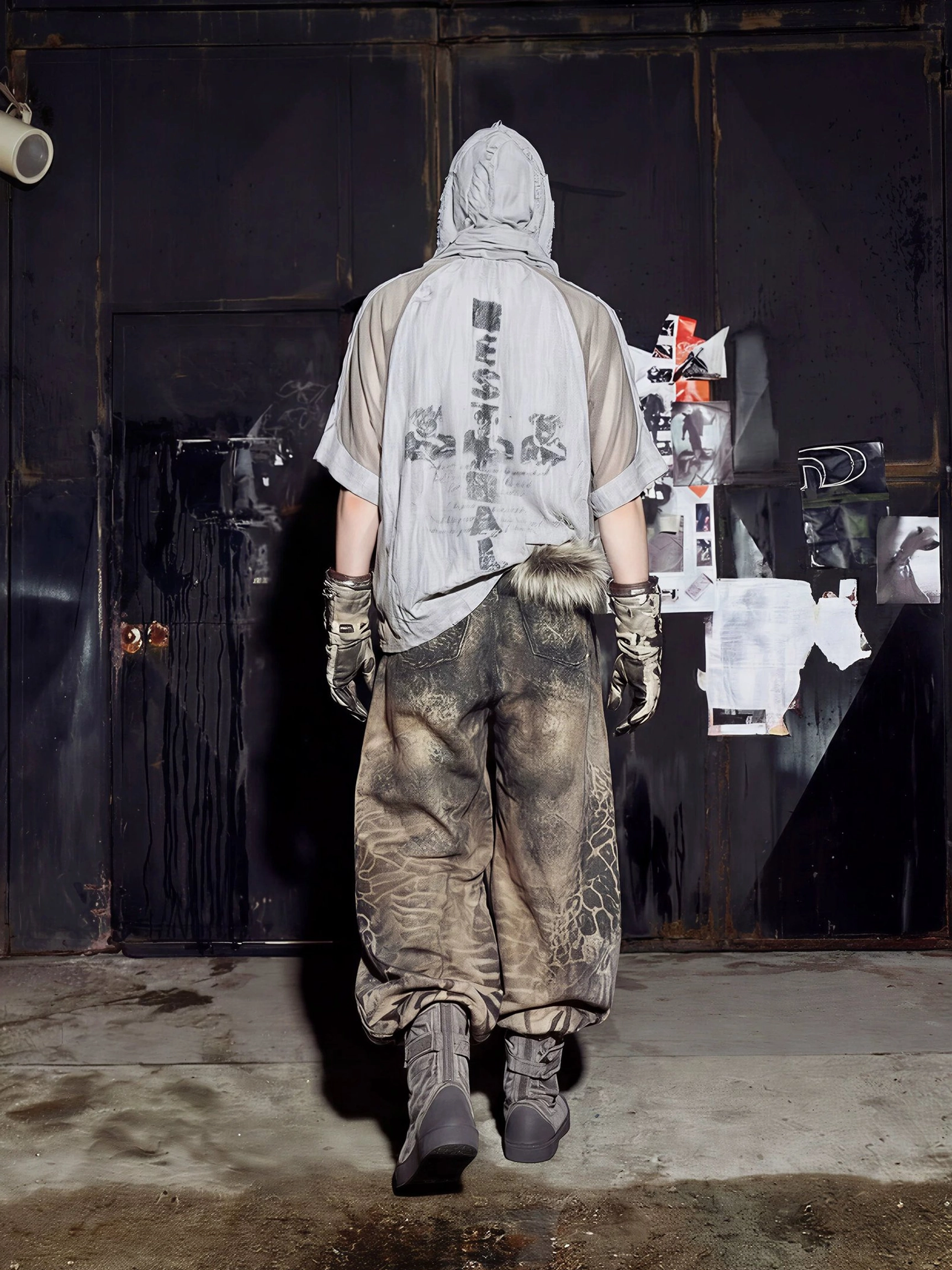 Rear full-body view of distressed wood grain gray mesh varsity jersey tee with bold gothic back lettering and graphic print