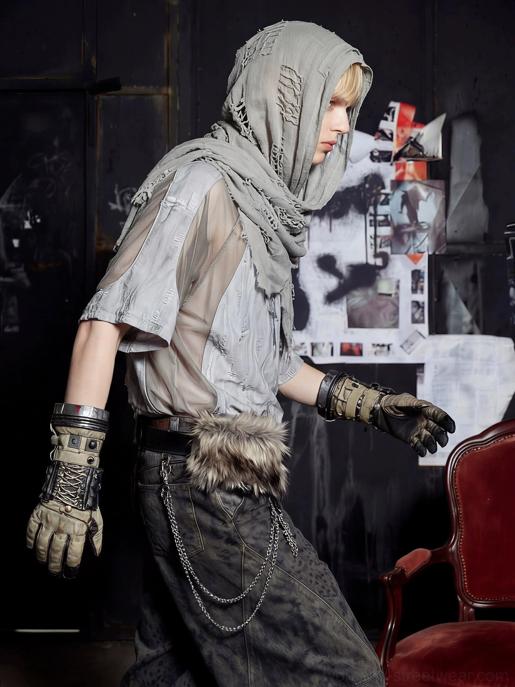 Side profile of a model wearing the distressed gray mesh hood scarf varsity jersey tee in an industrial grunge streetwear setting