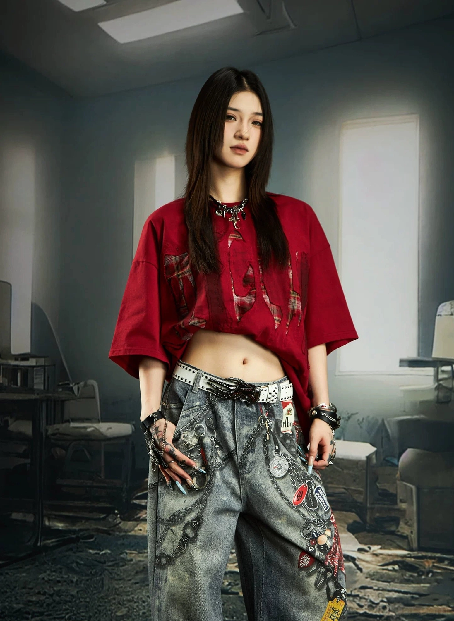 Red distressed plaid slash oversized graphic streetwear tee styled with wide-leg jeans and a decorative belt