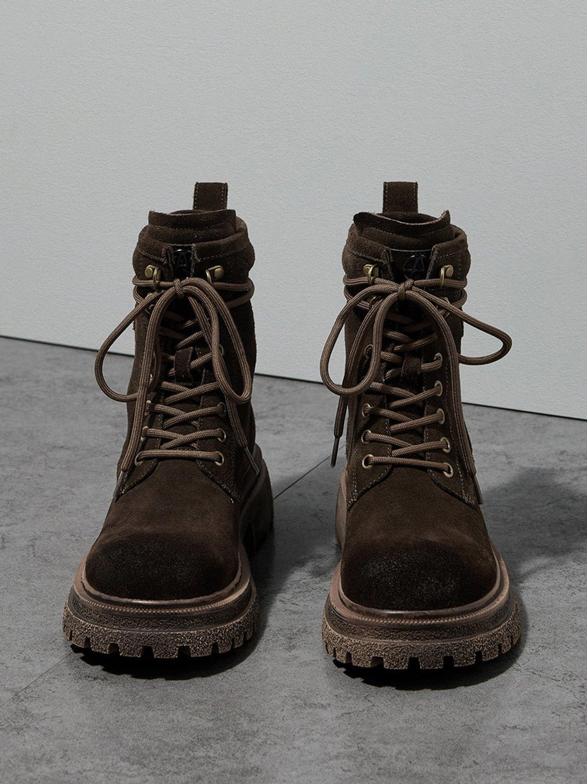 Distressed platform combat boots heel area detail showing pull tab counter support construction reinforcement