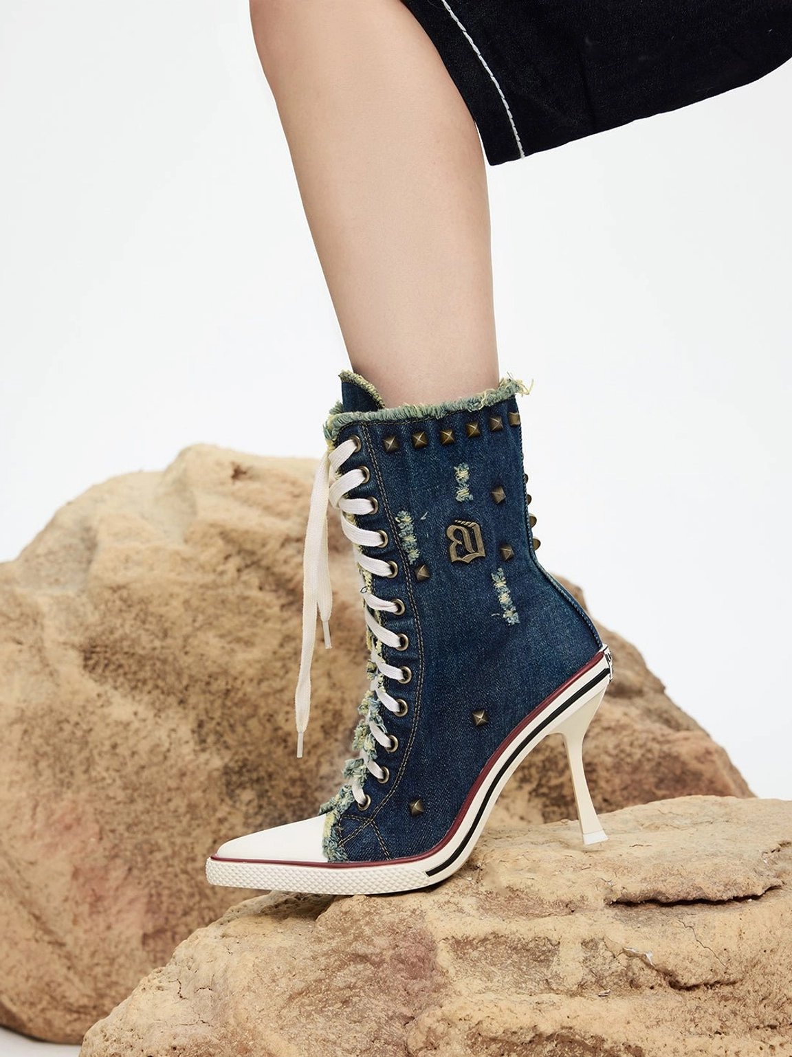 Blue denim lace-up platform boots with distressed edges and a bold high-heel silhouette