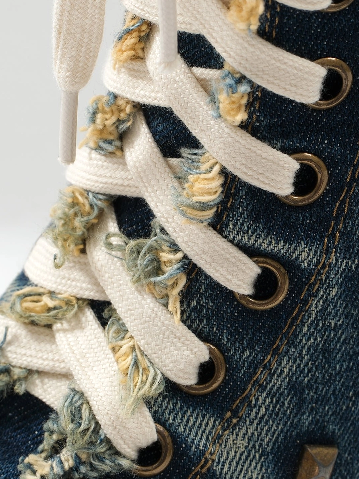 Fashion boots combining distressed denim texture, platform soles, and a high stiletto heel