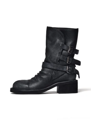 Distressed triple-buckle leather ankle boots for women in black side profile on a white studio background
