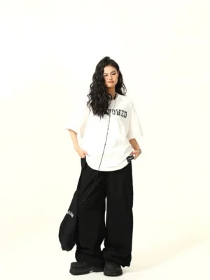 White oversized varsity graphic streetwear T-shirt front view with distressed black chest lettering