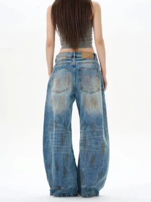Back view of women's distressed wide-leg denim jeans showing classic back pockets, washed blue finish, and relaxed Korean streetwear fit