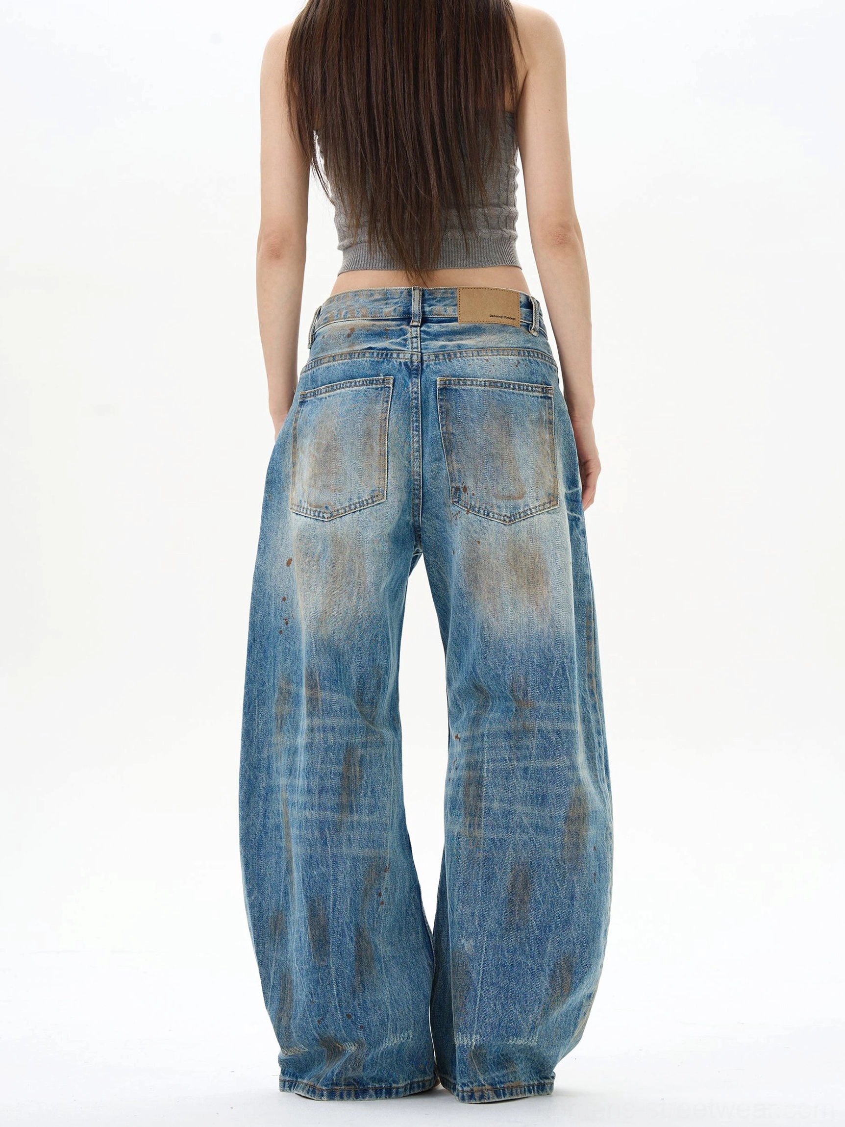 Back view of women's distressed wide-leg denim jeans showing classic back pockets, washed blue finish, and relaxed Korean streetwear fit