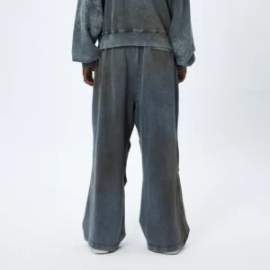 Rear view of oversized distressed wide leg sweatpants styled with a matching hoodie and high elastic waistband