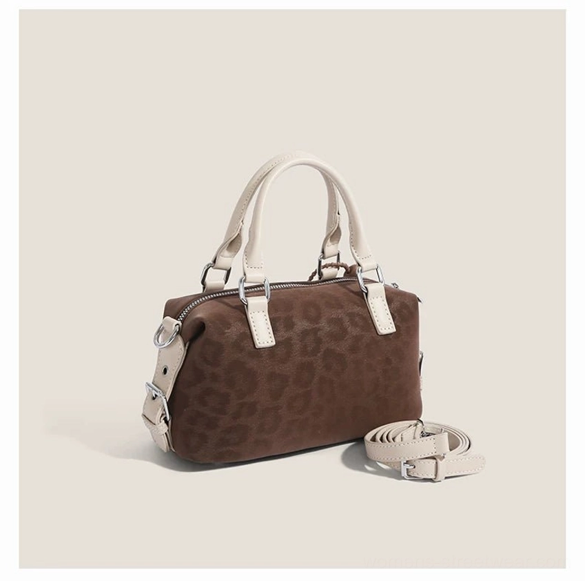 Doodle Charm mini streetwear barrel shoulder bag with textured faux leather finish, top zipper and playful embroidered detail
