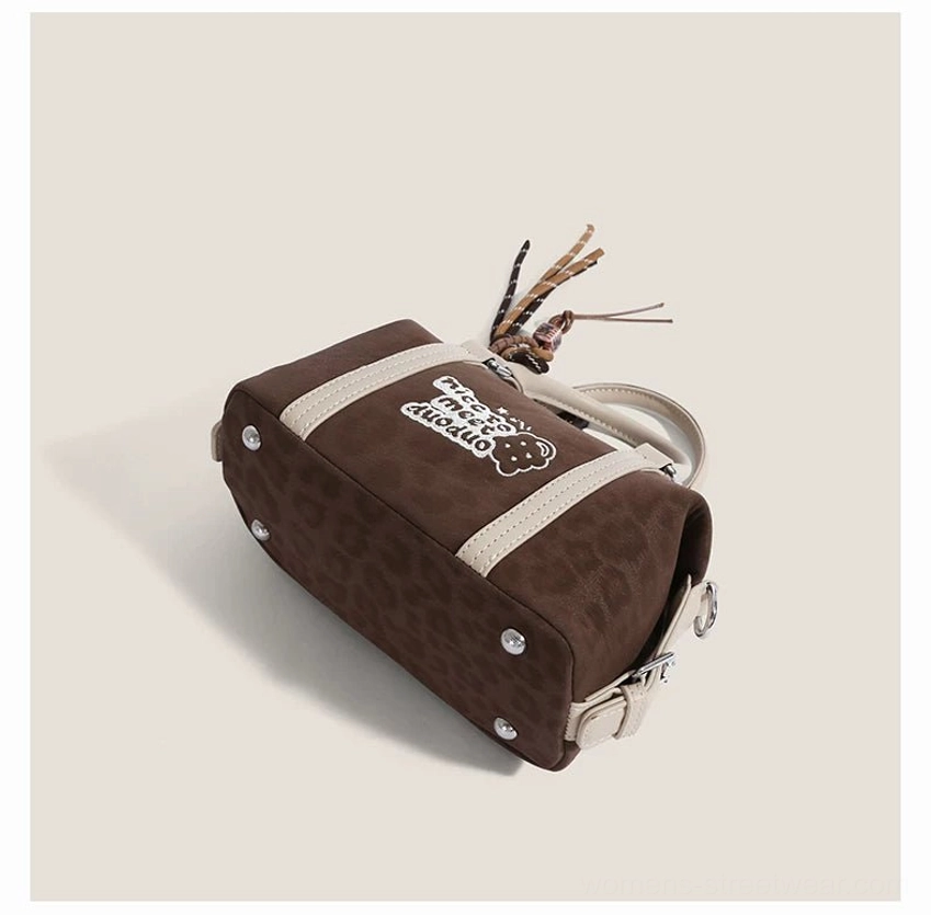 Compact Doodle Charm Boston bag for Korean fashion outfits with detachable shoulder strap, contrast trim and collectible charm styling