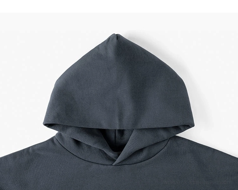 Dark gray oversized unisex hoodie close-up showing structured double-layer hood and neckline