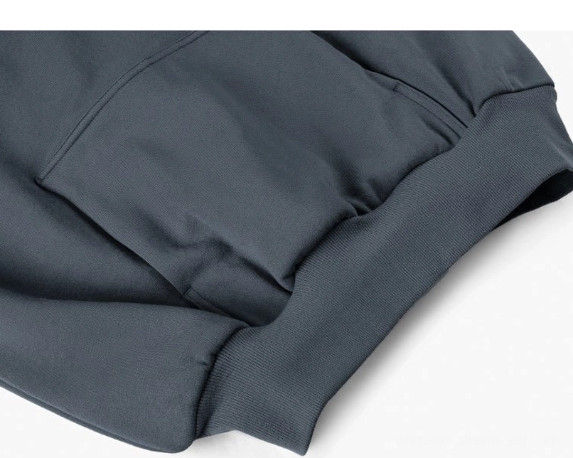 Dark gray oversized cotton blend hoodie close-up of kangaroo pocket ribbed cuff and sleeve detail