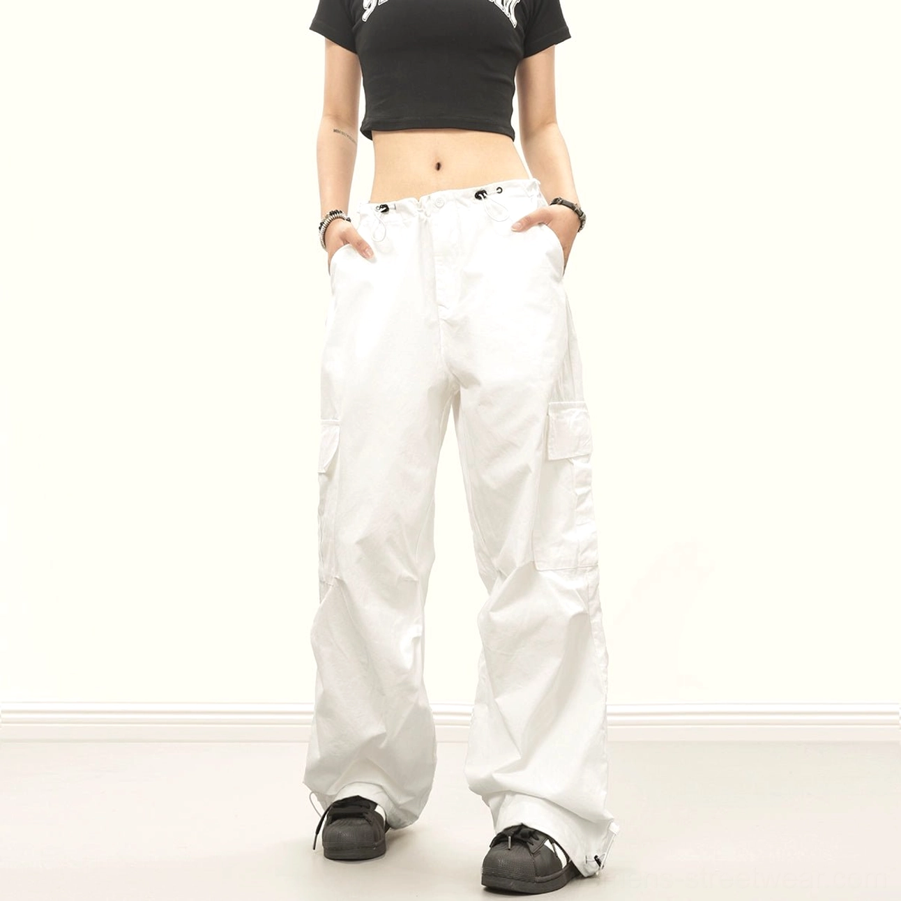 White downtown baggy streetwear cargo pants with loose wide legs, drawstring waist, side utility pockets and adjustable ankle cuffs