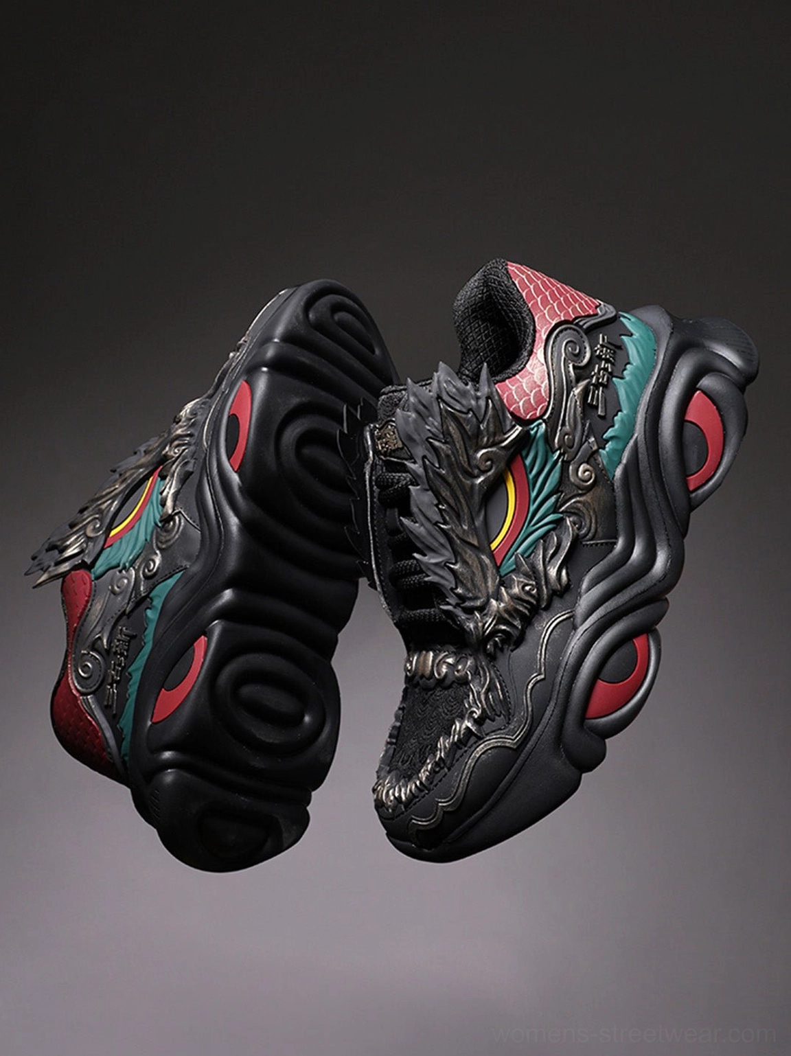 Overhead view of a pair of black dragon crest chunky sneakers displaying the vamp, outsole, matching dragon accents, and red circular sole details