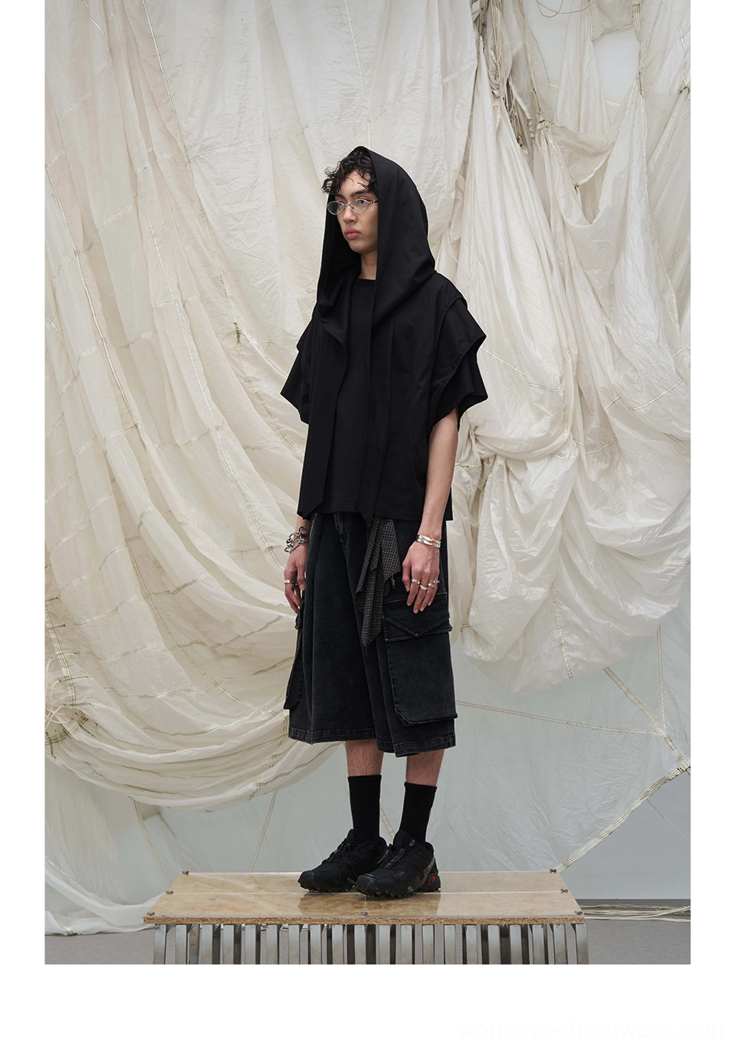 All-black streetwear outfit with oversized hooded top and black washed draped scarf cargo culotte shorts