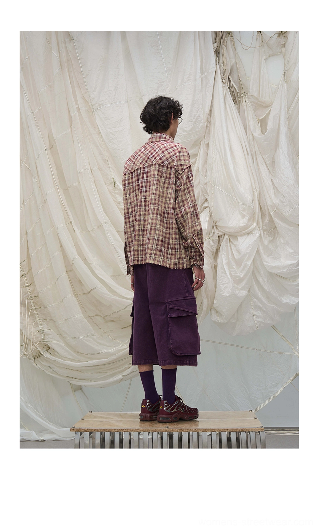 Rear view of purple draped scarf cargo culotte shorts showing back utility pockets and oversized wide-leg fit