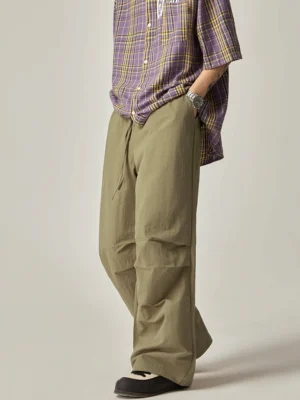 Green drawstring wide leg cargo pants styled with plaid shirt in Korean inspired streetwear outfit