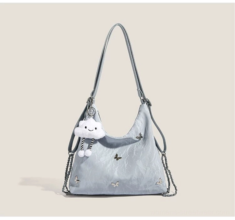 Blue dreamy cloud charm butterfly slouchy hobo shoulder bag with crinkled glossy finish and plush cloud pendant