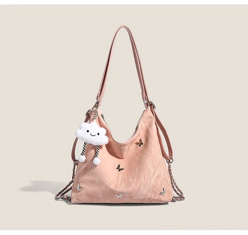 Dusty pink dreamy cloud charm butterfly slouchy hobo shoulder bag with crinkled texture brown straps and chain accents