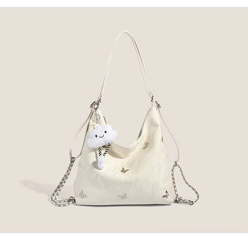 Off white cloud charm butterfly slouchy hobo shoulder bag with metallic butterfly details crinkled exterior and chain straps