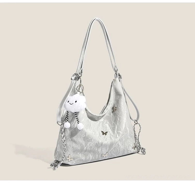 Silver dreamy cloud charm butterfly slouchy hobo shoulder bag with crinkled glossy texture and chain strap front view