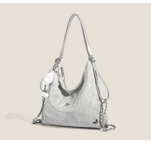 Silver cloud charm butterfly slouchy hobo shoulder bag with metallic butterfly accents and glossy crinkled exterior