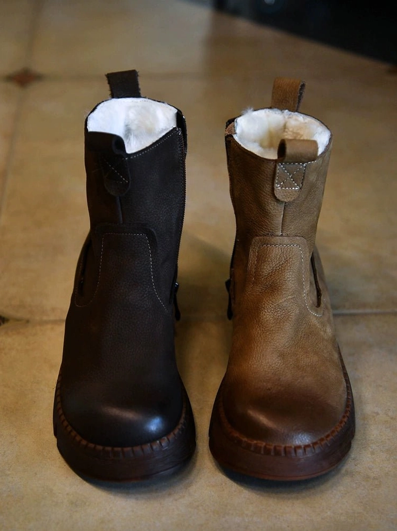 Front view of dual-tone brown shearling winter boots with distressed leather uppers, warm fur collars, and thick lug platform soles