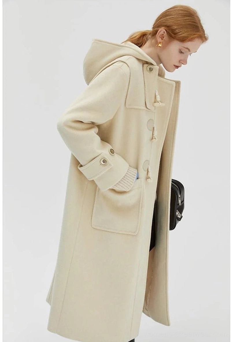 Duffle coat cuff detail showing adjustable metal buttons and sleeve fit customization