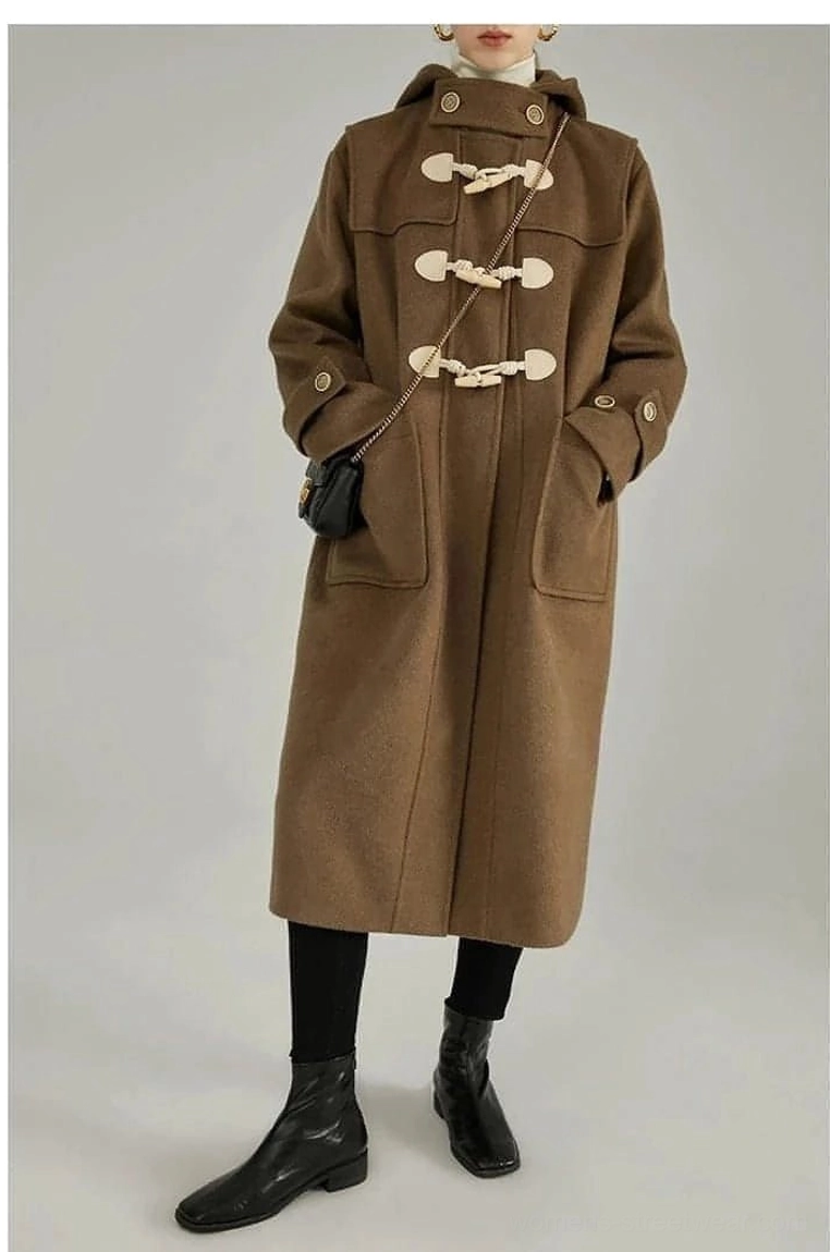 Wool duffle coat detail shot showing authentic horn toggle closure system metal cuff buttons craftsmanship